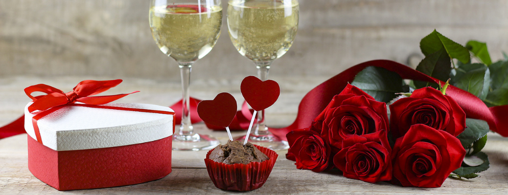 Roses, chocolates, and wine glasses
