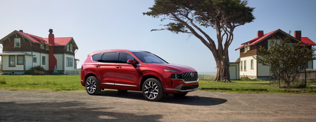 Red 2021 Hyundai Santa Fe in front of houses