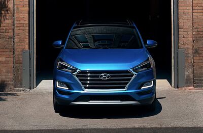 Hyundai Tucson exiting a garage.