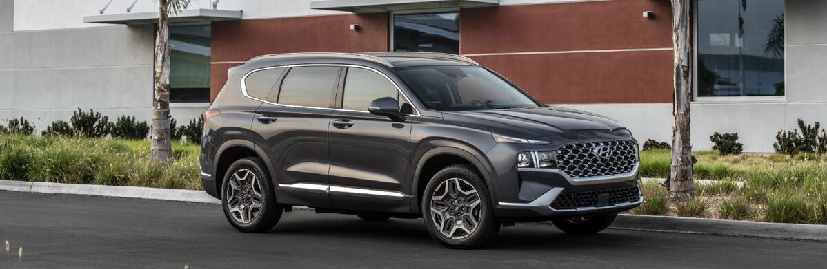 Gray Hyundai Santa Fe parked in front of a building.