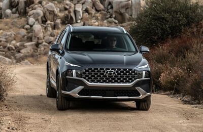 Hyundai Santa Fe driving on a dirt road.