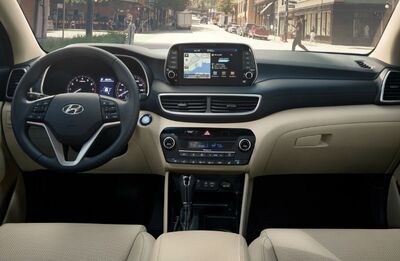 Hyundai Tucson interior with driver's seat and dashboard.