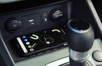 Smartphone charging wirelessly in a car.