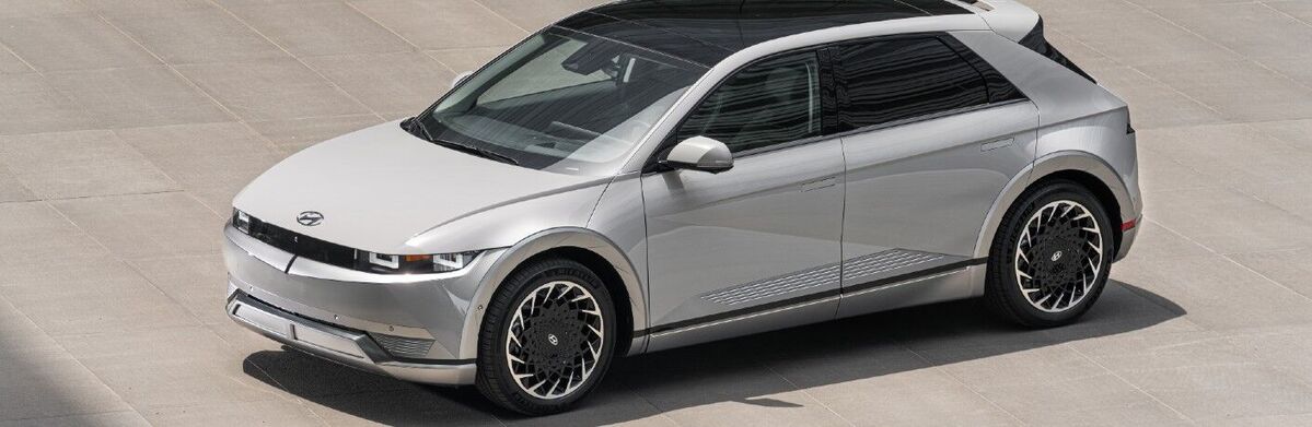 A silver Hyundai Ioniq 5 parked on a paved surface.