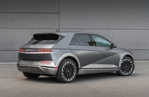 A rear view of a silver Hyundai Ioniq 5 parked in a parking lot.