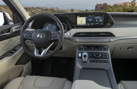 Hyundai Palisade interior with touchscreen navigation and coastal view.